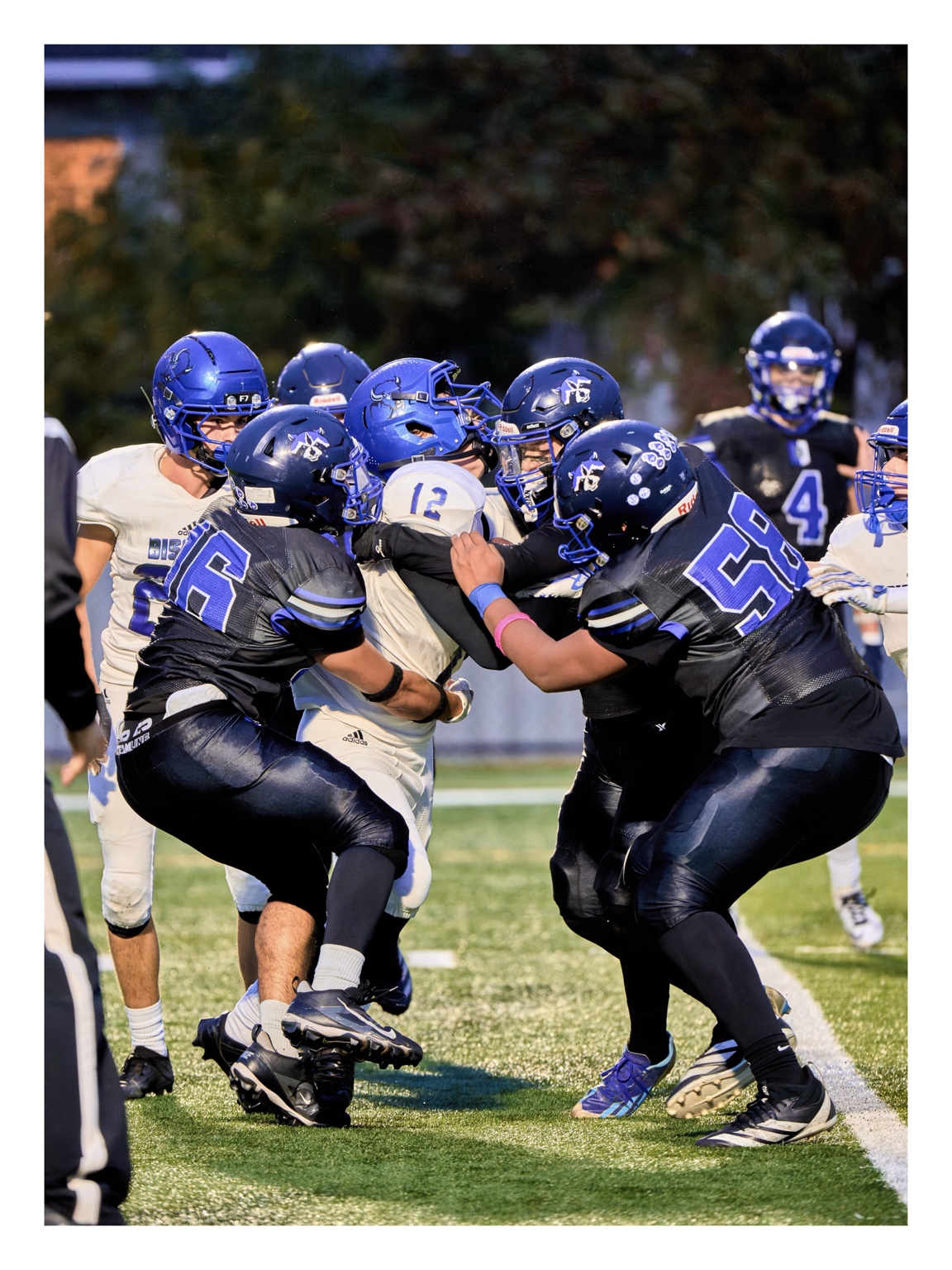 Football players meeting at the line during a play