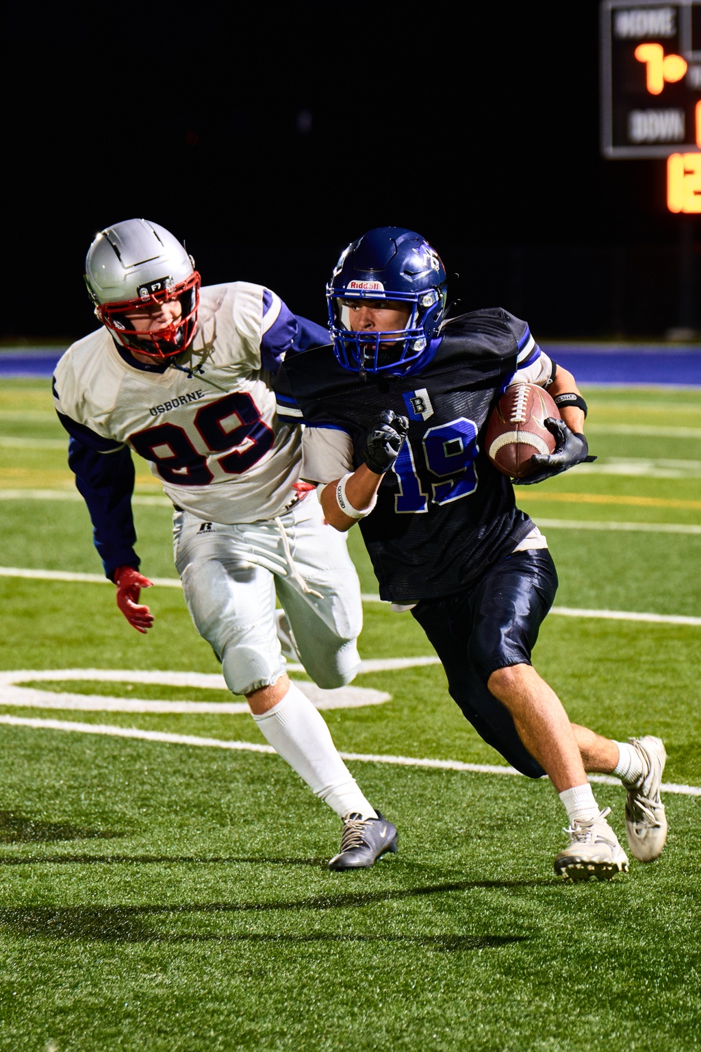 Bandits football player carrying the ball past a defender