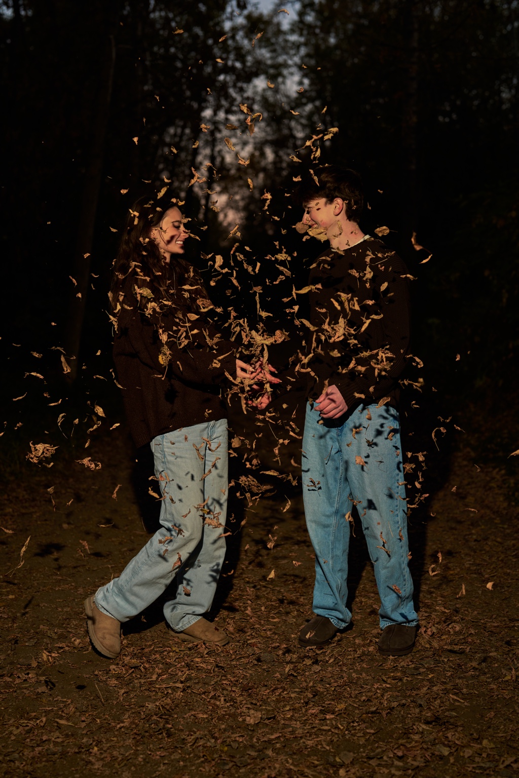 A couple tossing leaves during an autumn photo session