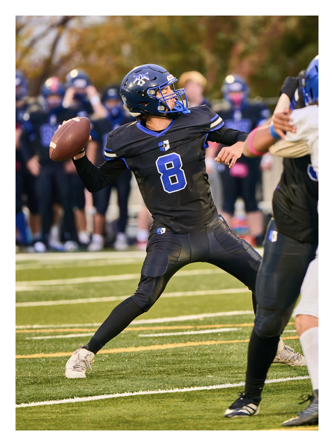 Football quarterback winding up to throw a pass